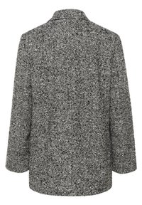 Manteau en laine noir et blanc à motif chevron, manches longues et col large, vu de dos.