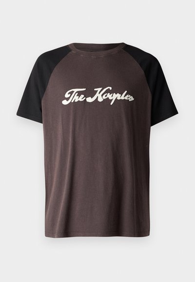 Hnědý a černý raglánový tričko s kulatým výstřihem, na kterém je bílým kurzívou napsáno "The Kayples" na hrudi. Měkká textura.