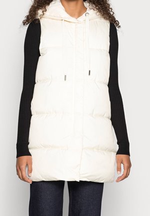 Puffy white vest with a hood, featuring a front zipper and drawstring. Black ribbed long sleeves contrast with the light-colored body.