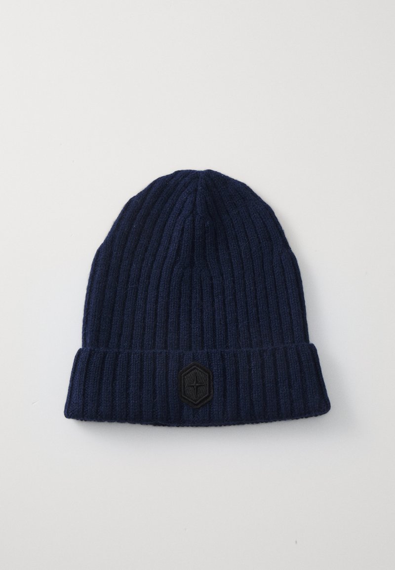 Navy beanie hat made of ribbed knit fabric, featuring a folded cuff and a black hexagonal logo patch on the front.