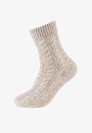 Chaussette en tricot beige avec un motif en torsades, une bordure côtelée et une surface texturée. Conçue pour la chaleur et le confort.