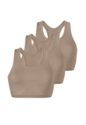 Three beige seamless sports bras with racerback design, arranged in a staggered row against a white background.