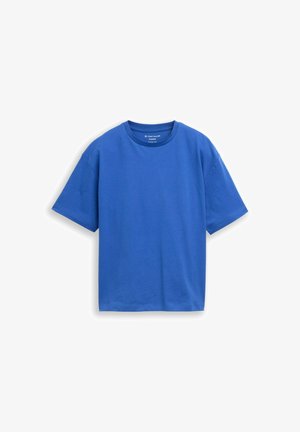 Maglietta semplice blu in cotone oversize a manica corta con scollo rotondo, mostrata stesa su sfondo bianco.