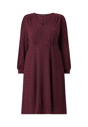Burgundy dress with long puff sleeves, V-neckline, and black polka dots. Features a pleated waist and a flowing skirt. Textured fabric.