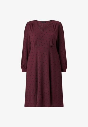 Burgundy dress with long puff sleeves, V-neckline, and black polka dots. Features a pleated waist and a flowing skirt. Textured fabric.