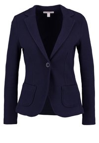 Námořnický blejzr s texturovanou tkaninou, jednořadým zapínáním na knoflík, dvěma předními kapsami a klopami s výstřihem. Čistý, upravený střih.