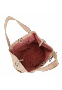 Sac à main en cuir tan avec une seule bandoulière. L'intérieur est doté d'une doublure en tissu rouge avec un motif à pois et d'une poche zippée.