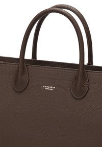 Brown leather handbag with textured surface, two rounded handles, and a discrete gold logo reading “CARLHEIM COPENHAGEN.”