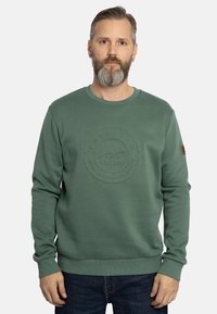 Groene sweatshirt met een textuur van een cirkelvormig logo, ronde halslijn en geribde boorden. Bevat een klein bruin accentpatch op de mouw.