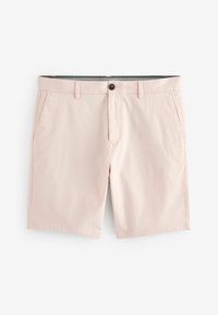 Pantalones cortos de hombre ajustados en rosa claro con bolsillos laterales, trabillas y un cierre de botón en la parte delantera, sobre un fondo blanco.