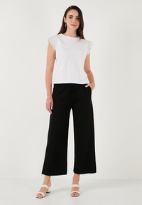 LELA REGULAR FIT - Hlače - black