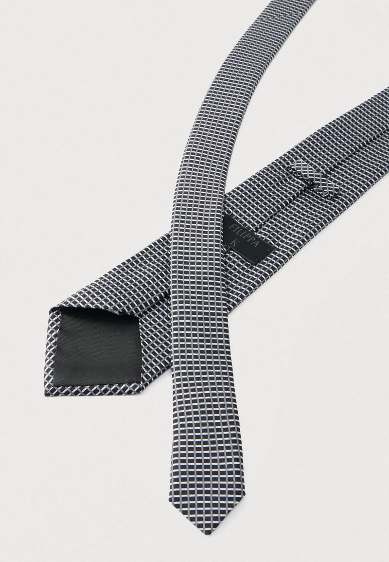 Patterned tie made from woven fabric, featuring a grid design in black, white, and light blue. The tie has a pointed tip and a smooth backing.