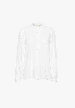 Valge pika varrukaga särk, millel on kõrge krae, nööbiga kinnitamine, volangiga esikene ja kogutud varrukaotsad. Valmistatud kergest kangast.