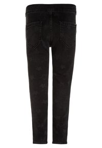 Svarta denimbyxor med stjärnmönster, utrustade med två bakfickor, slim-fit passform och en midja för en åtsittande passform.