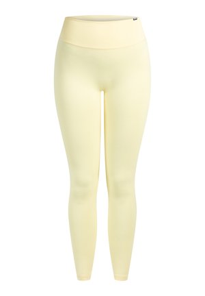 Lichtgele legging gemaakt van een glad, rekbaar materiaal. Hoge tailleband en een ontwerp in volledige lengte zonder zichtbare naden of patronen.