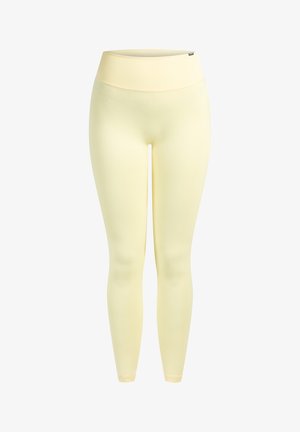 Mallas de color amarillo claro hechas de un material liso y elástico. Cintura alta y diseño de longitud total sin costuras ni patrones visibles.