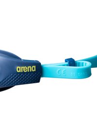 Marineblauwe zwembril met een gestructureerd rubberen frame, een verstelbare teal strap en een geel logo. Inclusief CE-markering voor conformiteit.