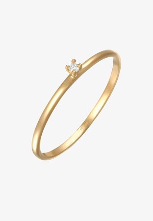 Goldring mit einem schlanken, glatten Band und einem einzelnen runden Diamanten, der in einer Vierfussfassung eingesetzt ist. Polierte Oberfläche, minimalistisches Design.