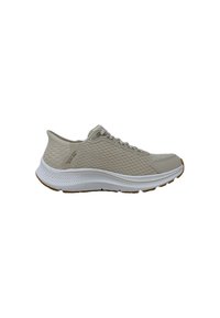 Scarpa sportiva beige chiaro con una tomaia testurizzata, dettagli in rete, intersuola bianca e suola in gomma. Presenta un sistema di allacciatura tradizionale.