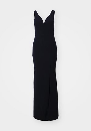 Black sleeveless gown with a plunging V-neckline, fitted silhouette, and side slit. Made of smooth, stretchy material for comfort.