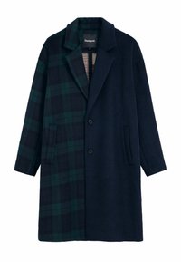 Double-breasted coat in dark navy and green plaid pattern, with a notched collar, two pockets, and textured fabric. Lined interior.