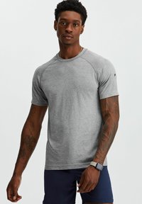 Gray athletic t-shirt with short raglan sleeves, made of soft material. Features a crew neck and subtle logo on the left shoulder.