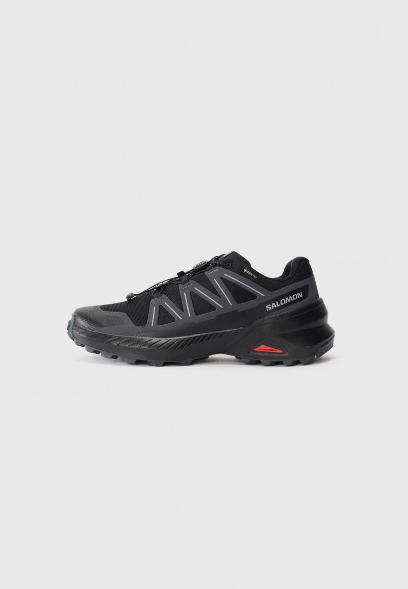 Black and gray Salomon trail running shoe with Gore-Tex and Contagrip outsole, shown in side profile on white background.