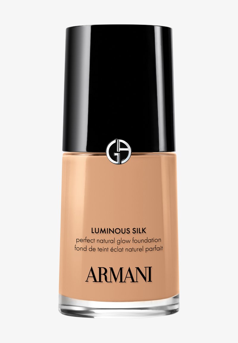 Flacon de fond de teint liquide Armani Luminous Silk avec capuchon noir et logo, teinte beige, étiqueté fond de teint éclat naturel parfait.