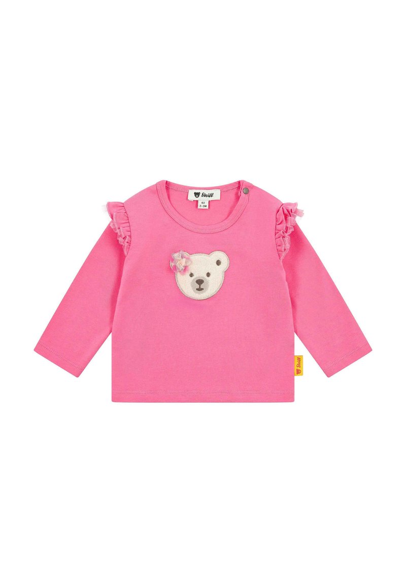 Rosa Langarmshirt mit einem Bärenkopf-Applikation in der Mitte und Rüschendetails an den Ärmeln. Hergestellt aus weichem Baumwollstoff.