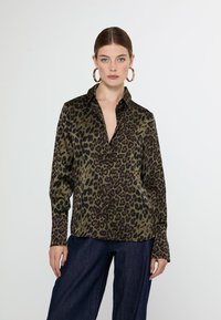Leopard print shirt in olive green and black, featuring a collared neckline and button-down front, with long sleeves and relaxed fit.