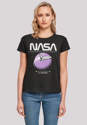 Black t-shirt featuring a NASA graphic. Design includes a purple planet and shuttle with white text. Short sleeves and relaxed fit.