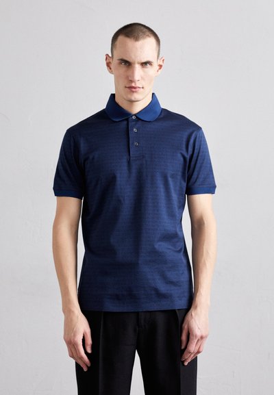 Navy polo shirt with a textured pattern, three buttons, and a contrasting collar. Short sleeves and a fitted design.