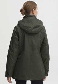 Dark green, textured jacket with a hood, visible stitching, and buttoned cuffs. Simple design with a loose fit.