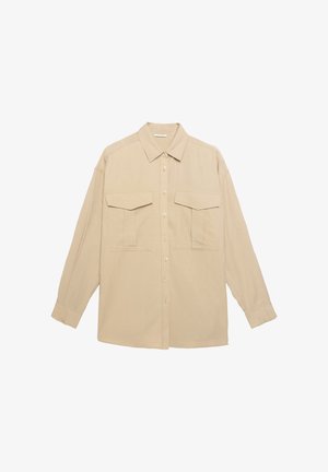 Beige overhemd met lange mouwen en een kraag, met twee borstzakken, knoopsluiting en een relaxte pasvorm. Glad stoftextuur.