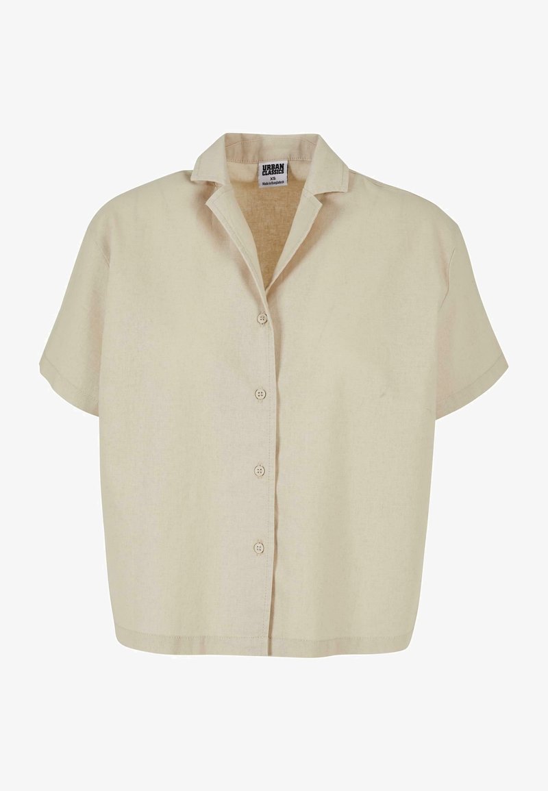 Chemise beige manches courtes avec col, quatre boutons sur le devant et une étiquette indiquant Urban Classics XS à l'intérieur de l'encolure.