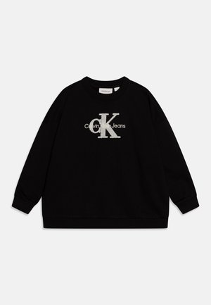 Czarna bluza z długim rękawem, z prążkowymi mankietami i dołem, z dużym białym logo tekstowym "cK" i "Calvin Klein Jeans" na środku przodu.