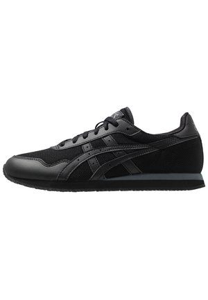 Basket de sport noire basse avec dessus en mesh et cuir, fermeture à lacets et semelle en caoutchouc texturée, vue de côté extérieur.