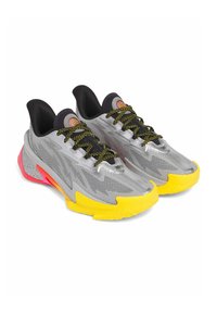Athletic shoes with a mesh silver upper, black accents, yellow and pink sole, and black and yellow speckled laces. Features a sleek, modern design.