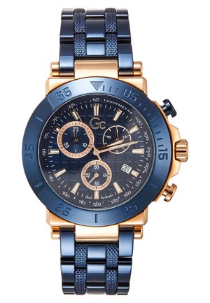 Men's chronograph watch featuring a navy blue metal band, gold accents, textured blue dial, multiple subdials, and tachymeter scale.
