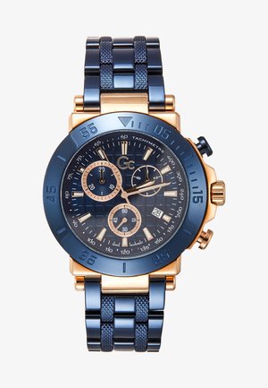 Orologio cronografo da uomo con cinturino in metallo blu navy, accenti dorati, quadrante blu texturizzato, multipli sottoquadranti e scala tachimetrica.