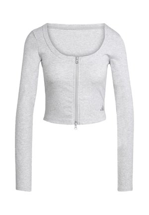 Top gris court à manches longues en tissu côtelé, présentant une fermeture éclair centrale et un col arrondi. Petit logo sur l'ourlet.