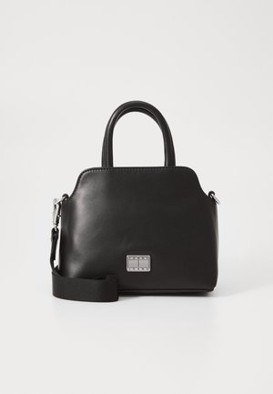 Black leather handbag with short handles, detachable shoulder strap, and small metal Tommy Jeans logo plaque on front.