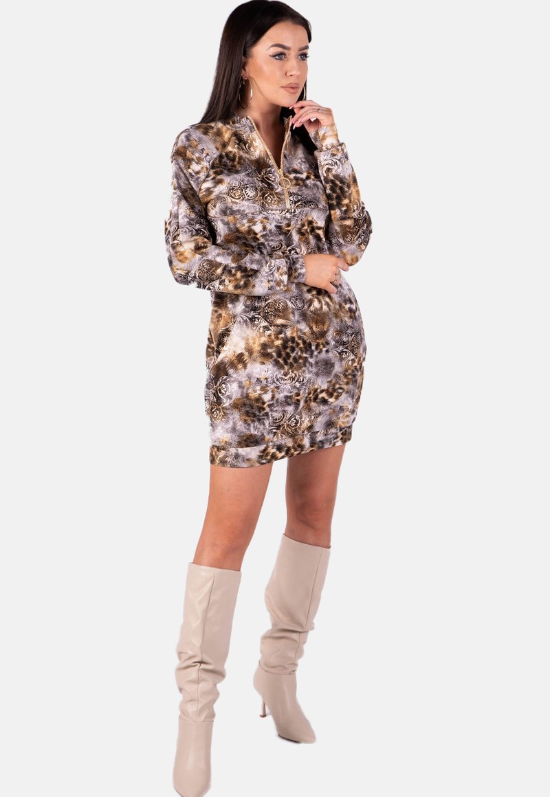 Long-sleeve dress in a brown, gray, and cream abstract pattern, featuring a zip collar. Accompanied by knee-high beige boots.