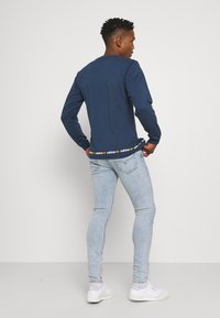 Levi's® SKINNY TAPER - Calças de ganga de corte skinny - light indigo - worn in