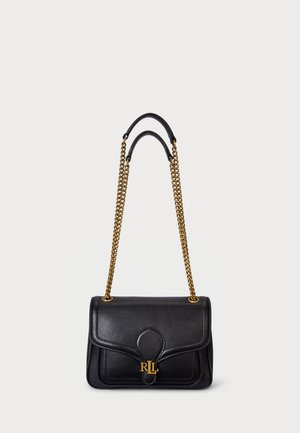 Black leather handbag with a structured design, gold chain strap, and embossed logo detail on the front. Features smooth texture and flap closure.
