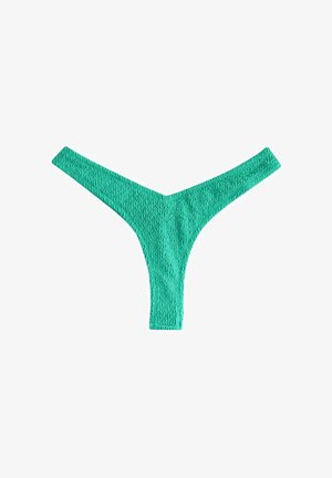 Grön stringtrosa i strukturerad tyg, med en V-formad front och smala sidor. Inga synliga dekorationer eller metalldelar.