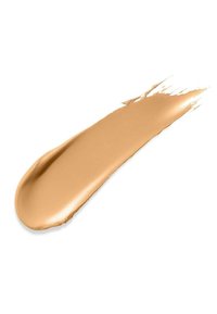 Échantillon de fond de teint liquide beige avec une texture lisse et crémeuse, présentant une finition brillante et des bords doux sur un fond blanc.