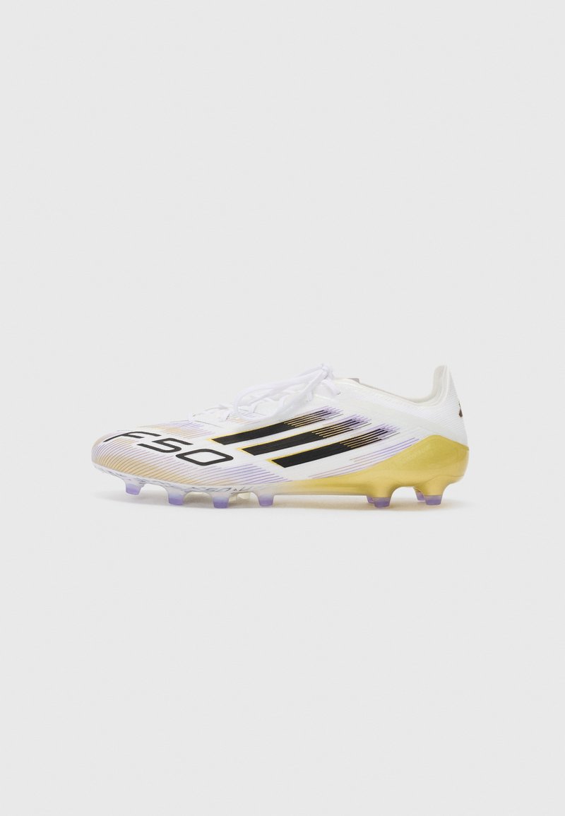 White soccer cleat with black stripes, a gradient yellow and purple sole, and a textured upper featuring a minimalist design.