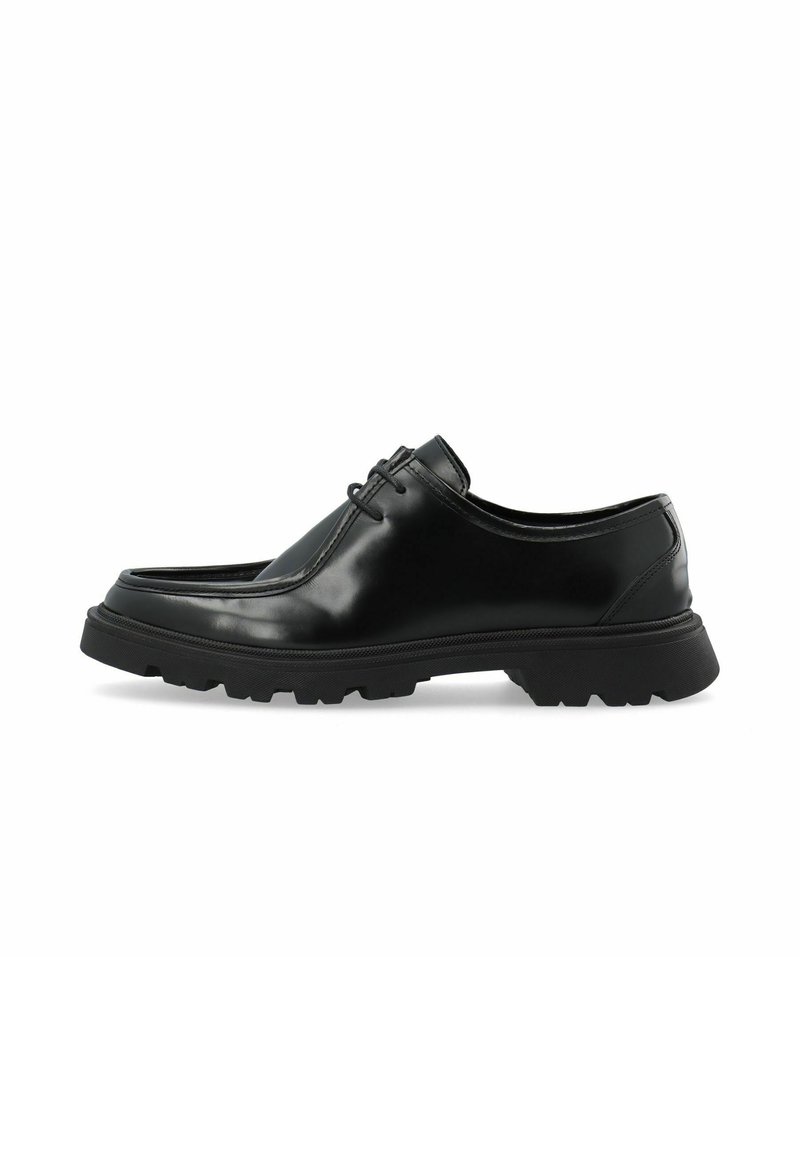 Schwarze Lederhalbschuhe mit glatter Oberfläche, runder Spitze und einer dicken, strukturierten Gummisohle. Mit dezentem Schnürdetail.