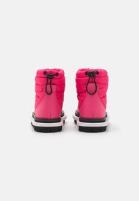 Rosa fluffiga ankelstövlar med en texturerad yta, elastiskt snörningssystem, svarta gummisulor och en kontrasterande vit mellansole-detalj.